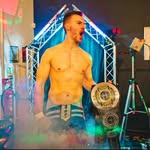 Ben Gedling standing with a championship belt